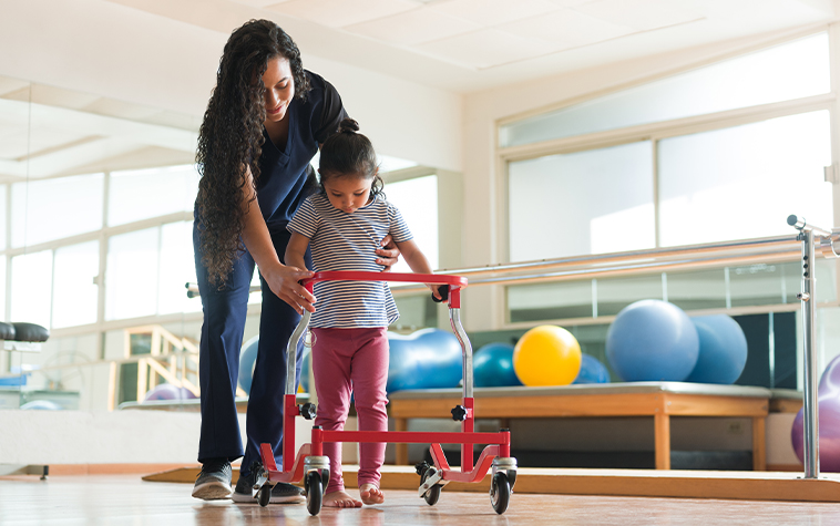child assisted with a walker